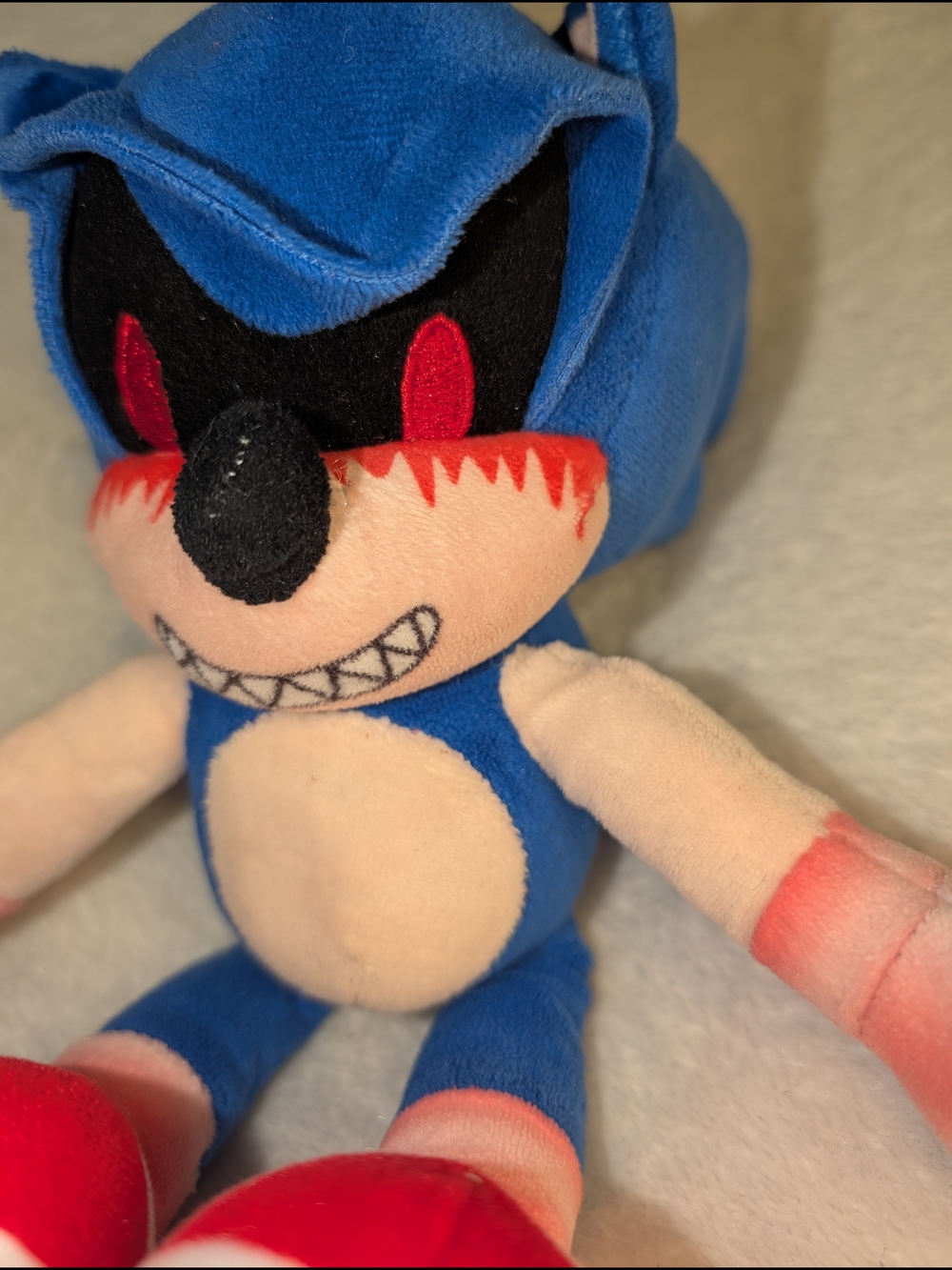 Blue Creepy Character Plush Toy with Red Accents